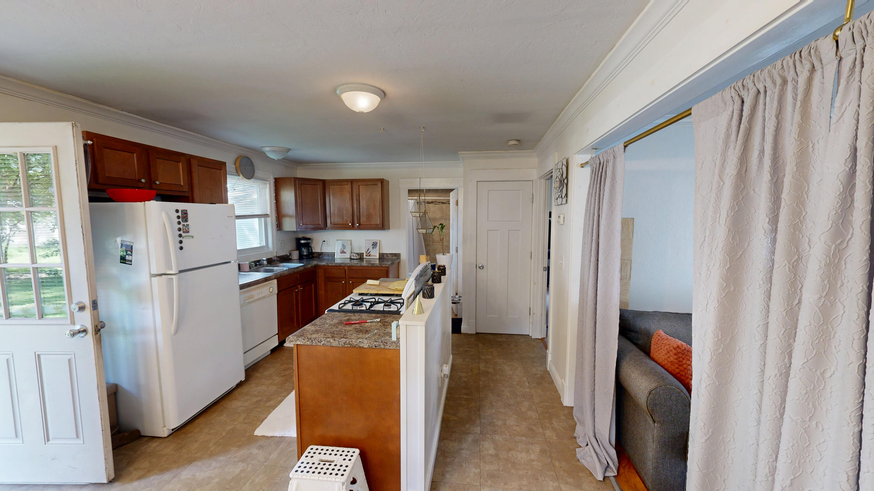 4305 Colfax Street Gary, IN 46408 - Photo 8 of 27 a kitchen with a refrigerator a stove top oven a sink and dishwasher