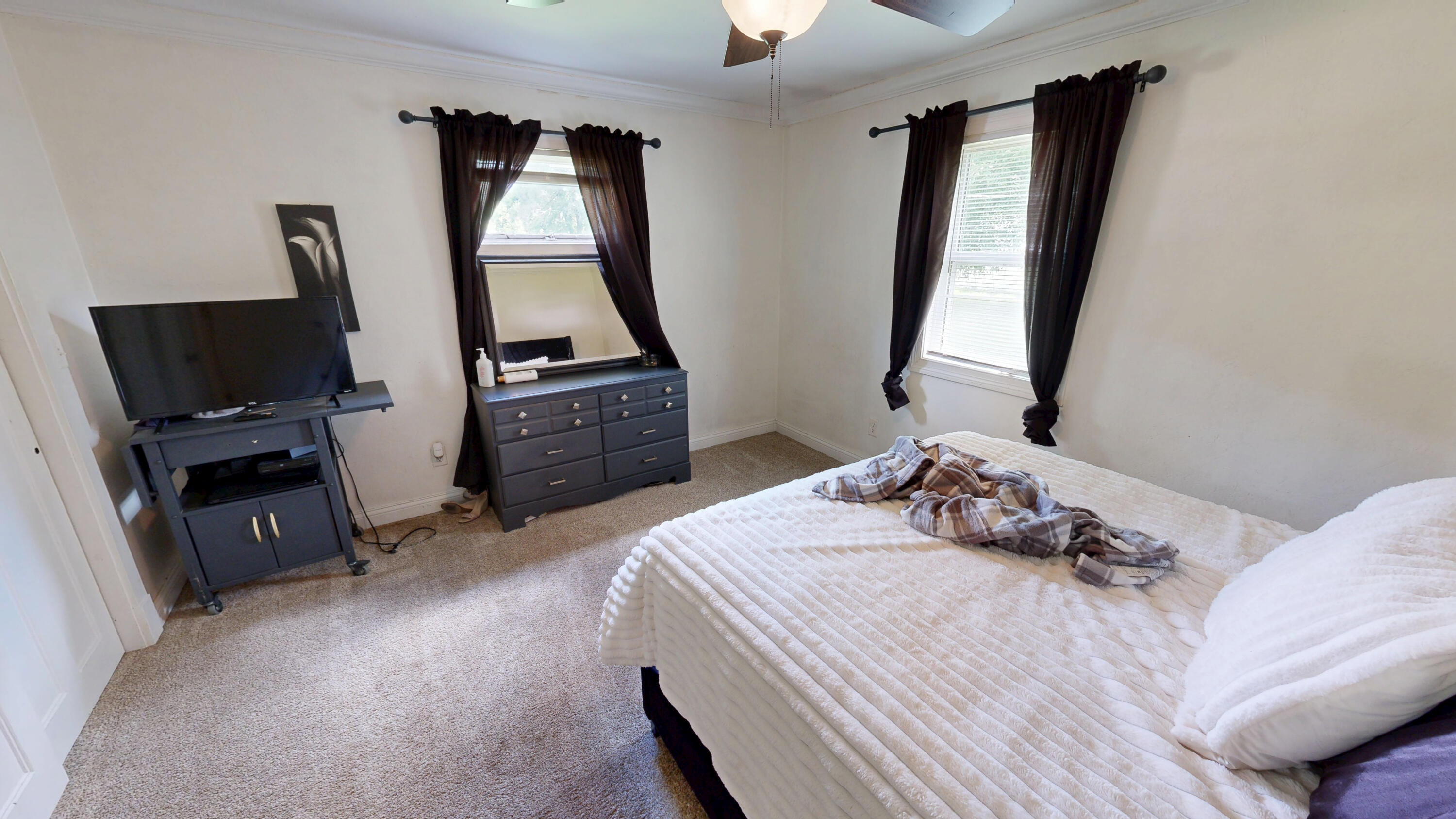 4305 Colfax Street Gary, IN 46408 - Photo 10 of 27 a bedroom with a bed a mirror on dresser and a window