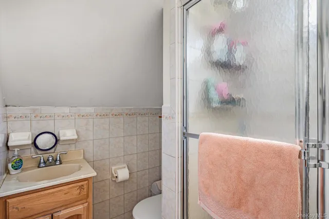 a bathroom with a toilet sink and mirror