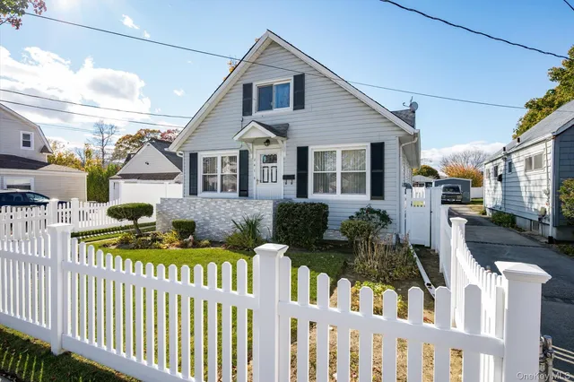 a front view of house yard and wooden fence