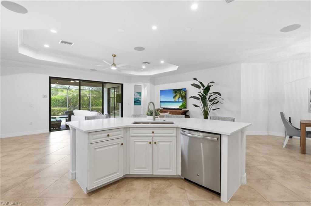 9479 Piacere Way Naples, FL 34113 - Photo 8 of 48 White cabinetry with gold-tone hardware, stainless steel dishwasher, undermount sink, and recessed lighting