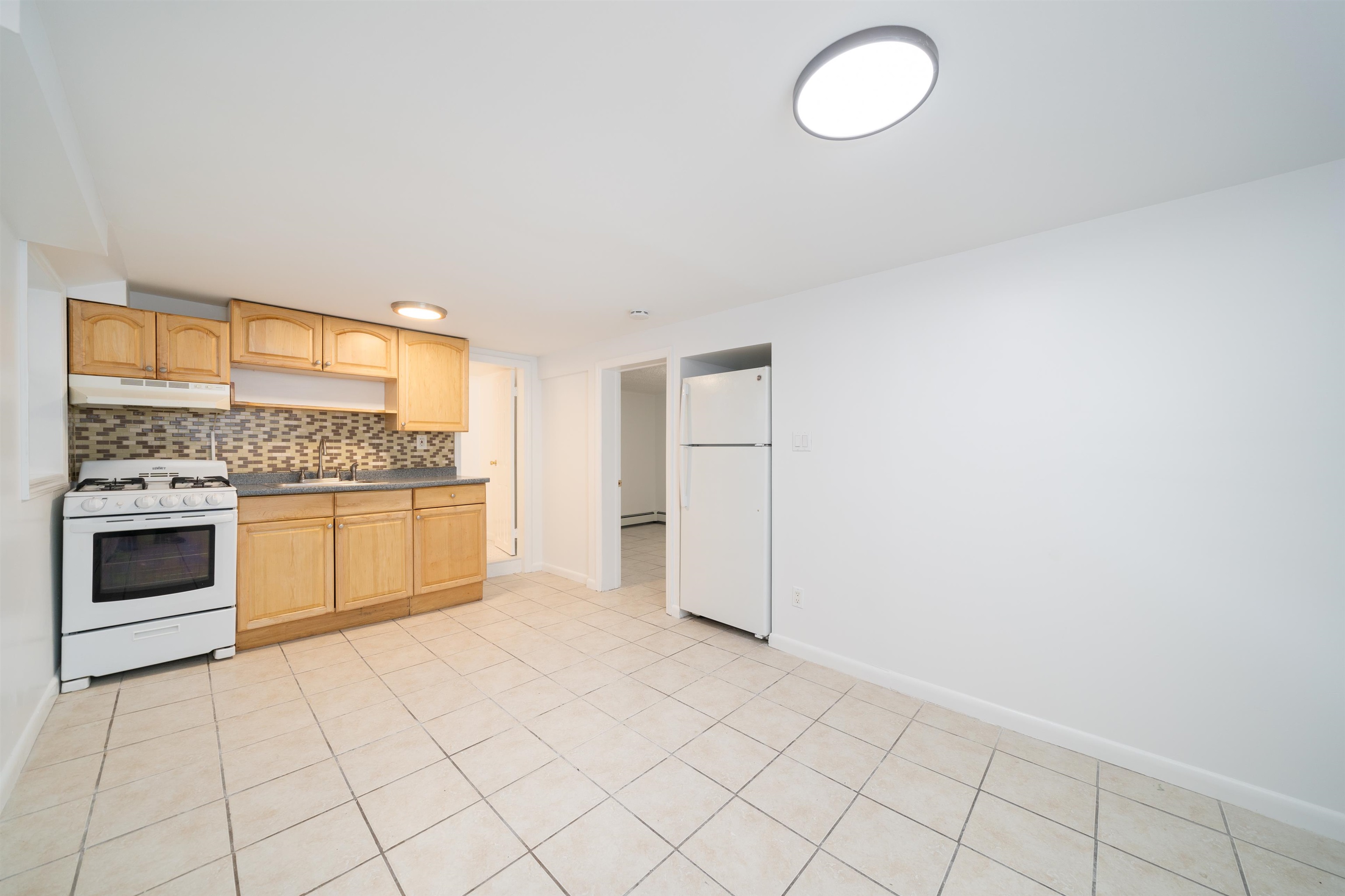 a kitchen with granite countertop white cabinets and white appliances