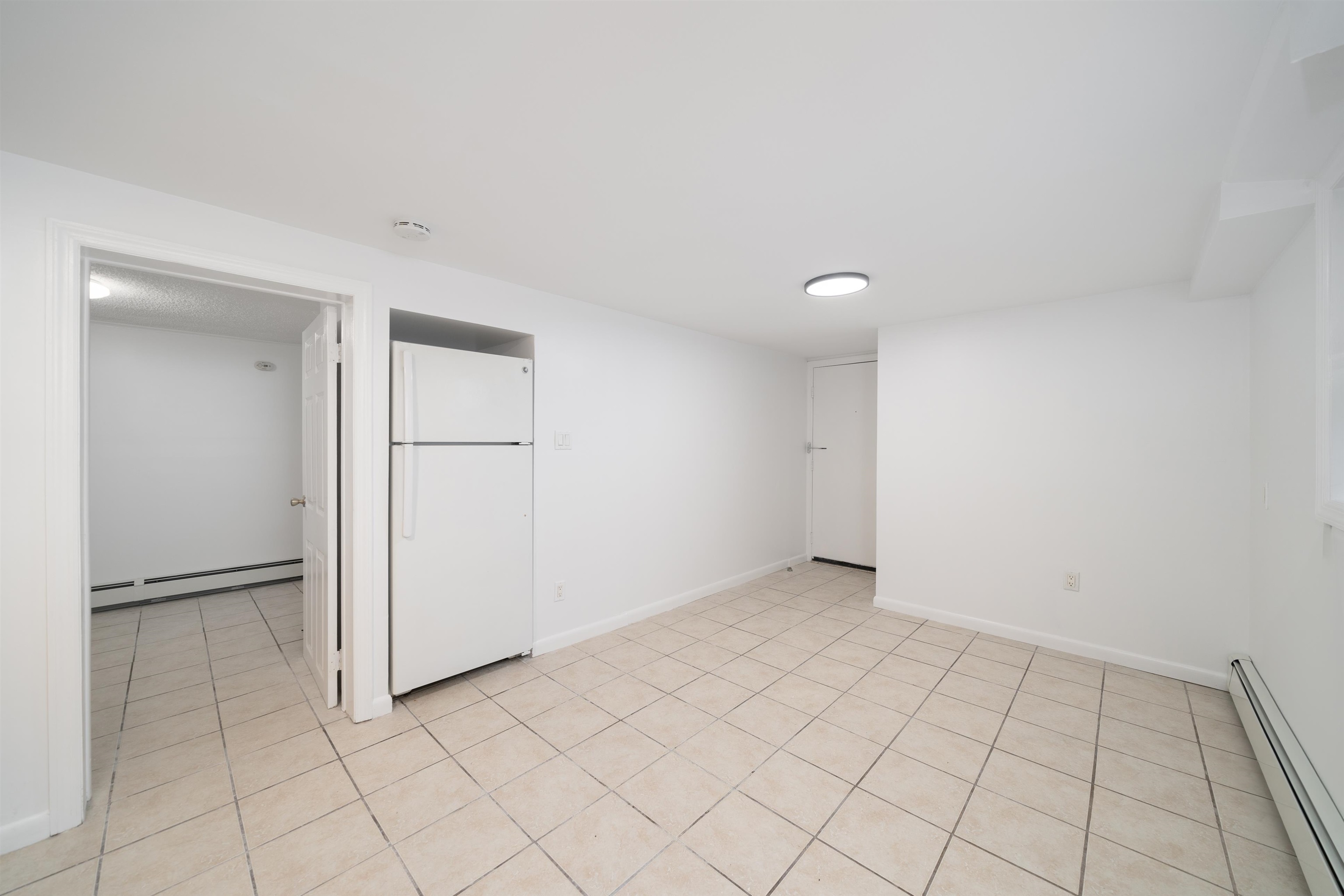 720 Liberty Avenue, Unit 1 North Bergen, NJ 07047 - Photo 3 of 9 an empty room with white wall and cabinet