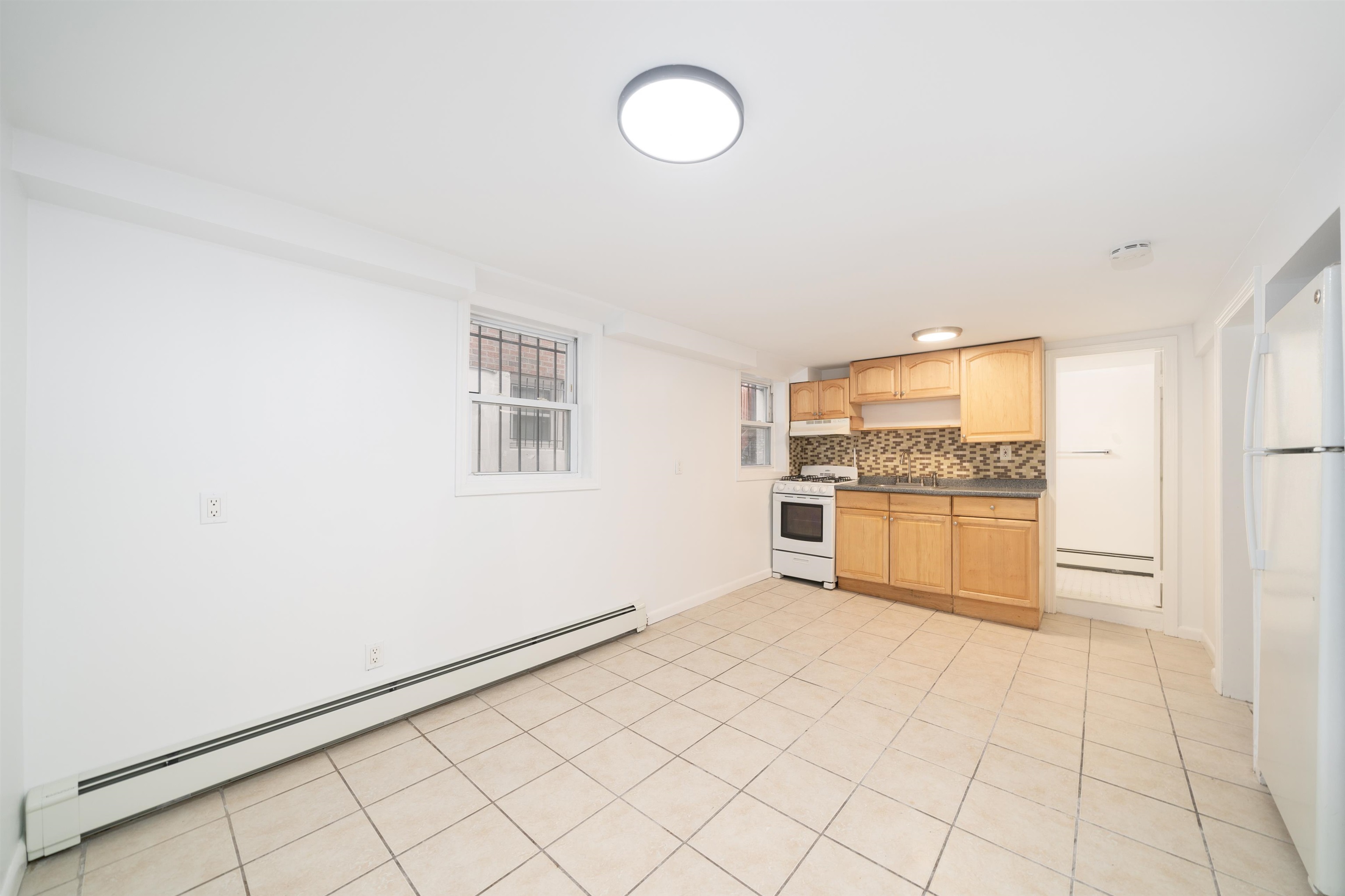 720 Liberty Avenue, Unit 1 North Bergen, NJ 07047 - Photo 4 of 9 a kitchen with granite countertop white cabinets and white appliances