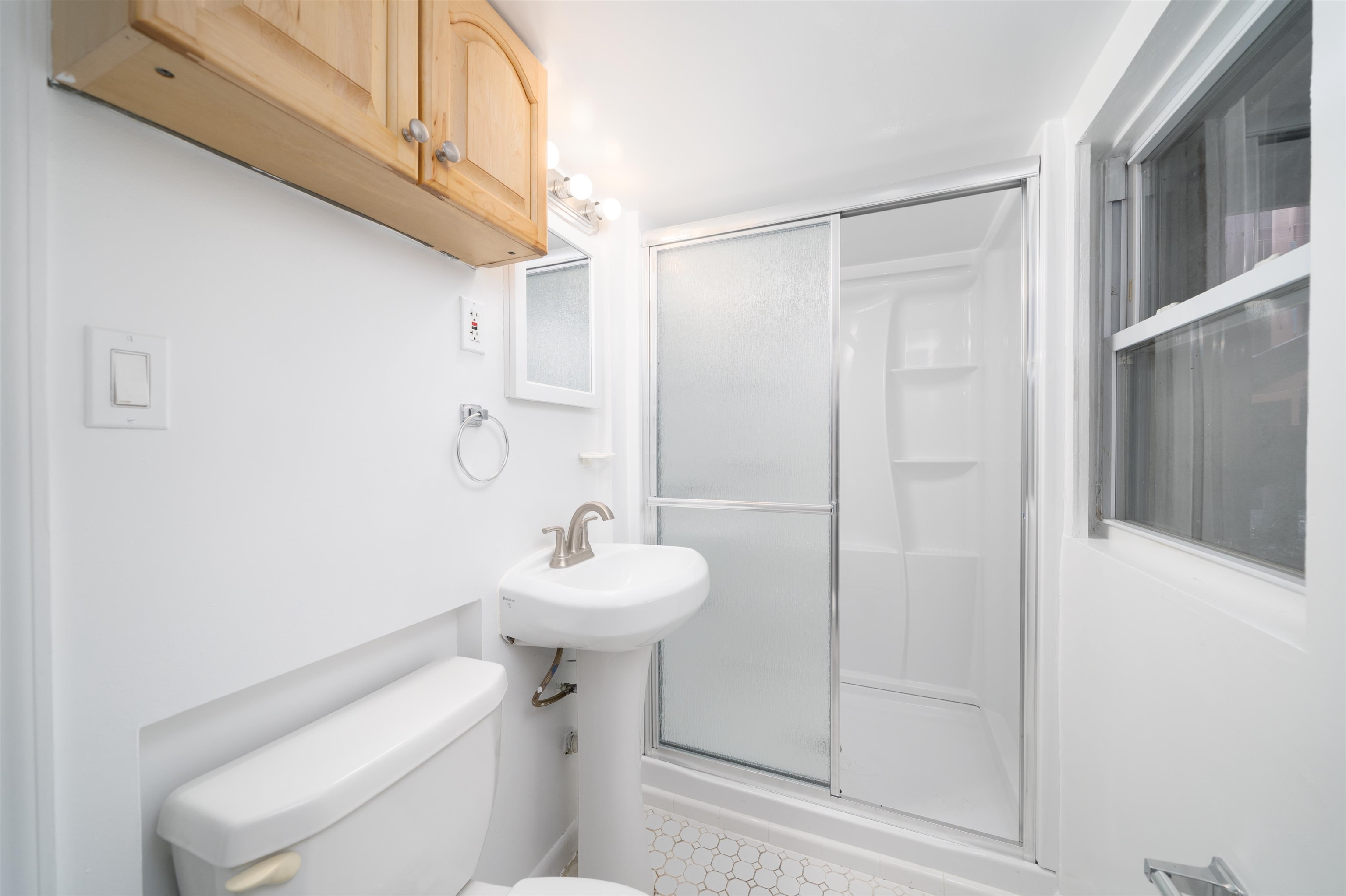 720 Liberty Avenue, Unit 1 North Bergen, NJ 07047 - Photo 6 of 9 a bathroom with a sink a toilet and shower