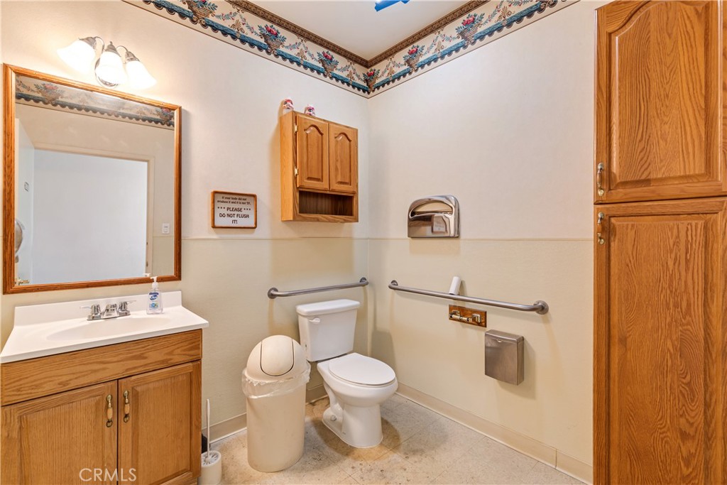 22706 Aspan Street, Unit 16 Lake Forest, CA 92630 - Photo 12 of 34 a white toilet sitting next to a bathroom sink