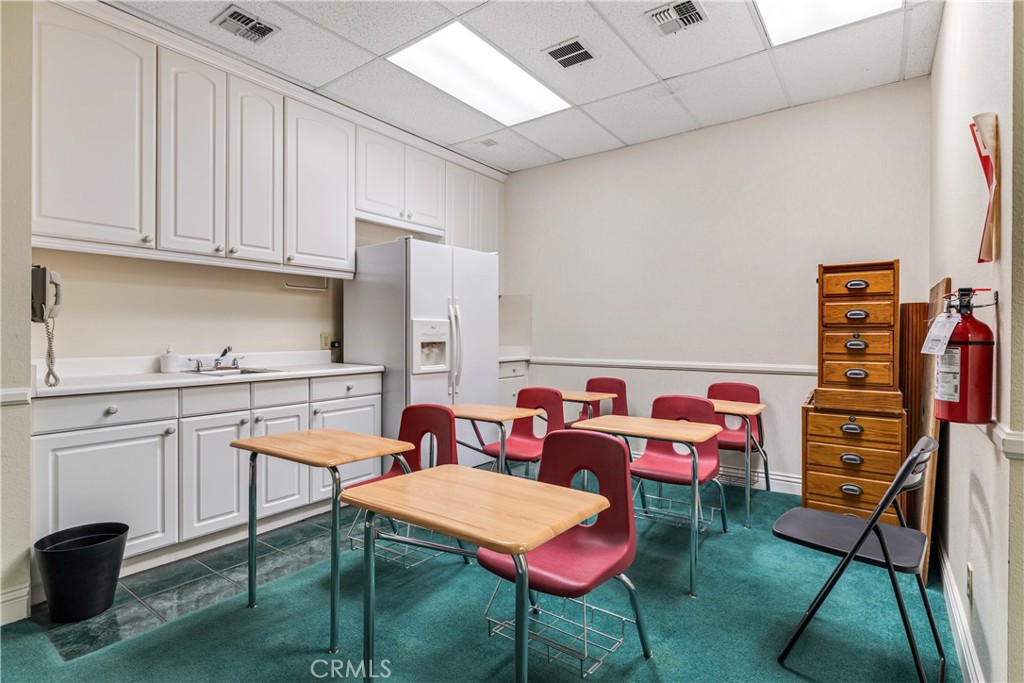 22706 Aspan Street, Unit 16 Lake Forest, CA 92630 - Photo 14 of 34 a reading room with furniture a rug and a bookshelf