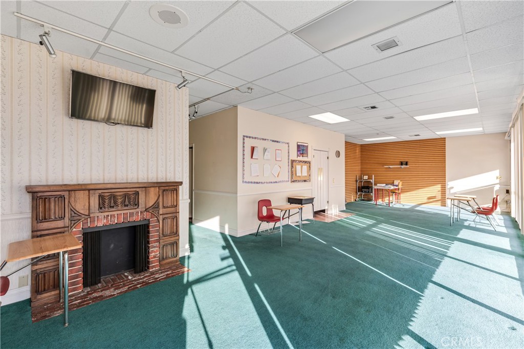22706 Aspan Street, Unit 16 Lake Forest, CA 92630 - Photo 7 of 34 a living room with furniture a flat screen tv and a fireplace