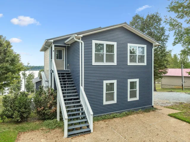 a front view of a house with plants