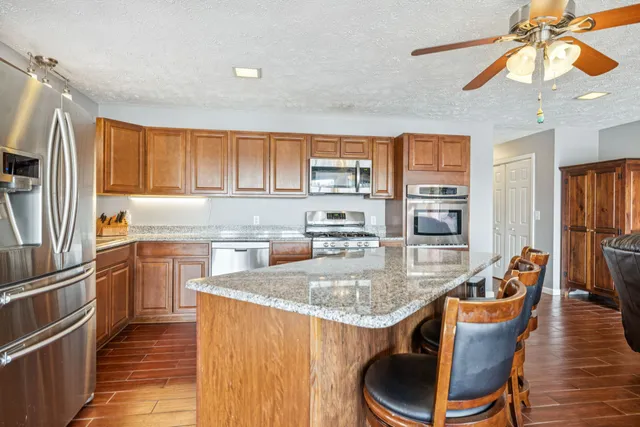 a living room with furniture flat screen tv and wooden floor