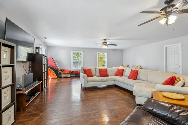 a bedroom with a large bed and a chandelier