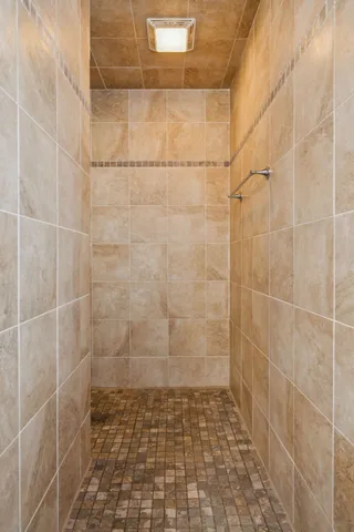 a view of a swimming pool with couches chairs and potted plants