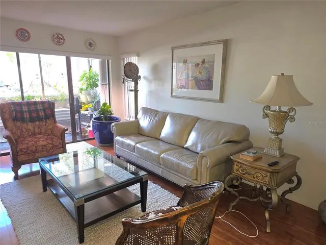 a living room with furniture and a floor to ceiling window