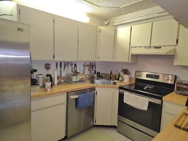 a kitchen with a sink stove and cabinets