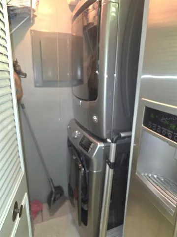a bathroom with a granite countertop bathtub shower sink and toilet