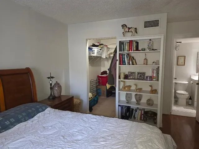 a bedroom with a bed and flat screen tv