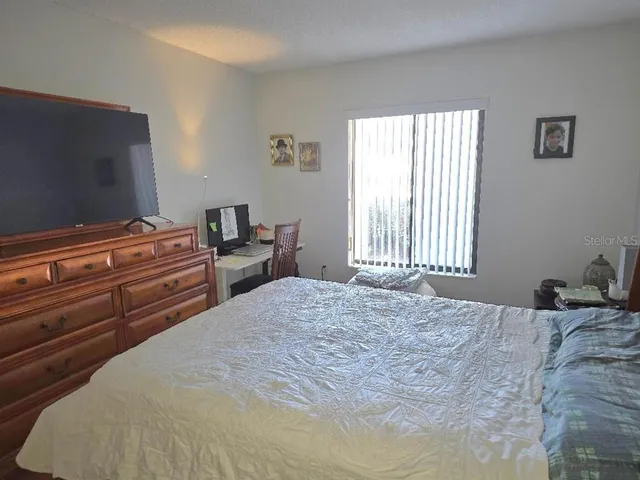 a bed sitting in a bedroom next to a window