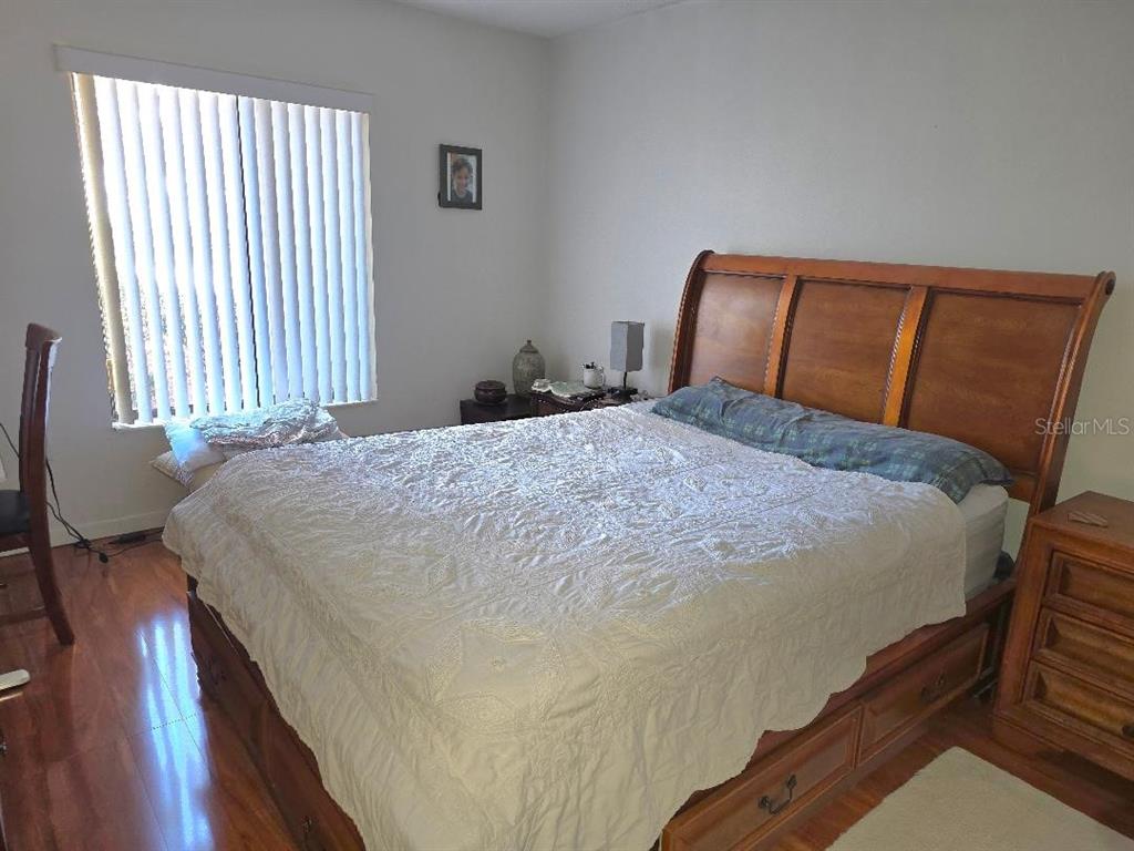 1281 Pine Ridge Circle East, Unit E1 Tarpon Springs, FL 34688 - Photo 10 of 12 a bed sitting in a bedroom next to a window