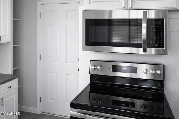 a stove top oven sitting inside of a kitchen