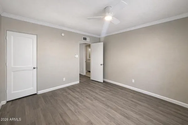 a view of an empty room with wooden floor