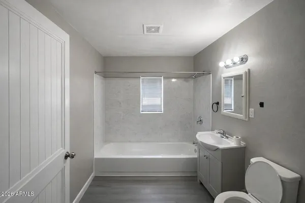 a bathroom with a bathtub a sink and a mirror