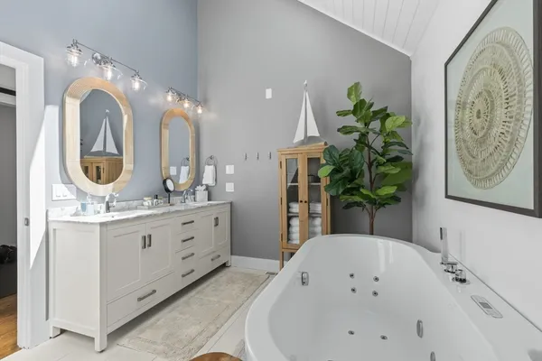 a bathroom with a double vanity sink and a mirror