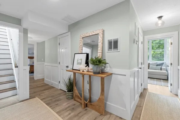 a bedroom with two beds and painting on the wall