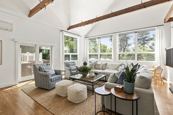 a living room with furniture and floor to ceiling windows