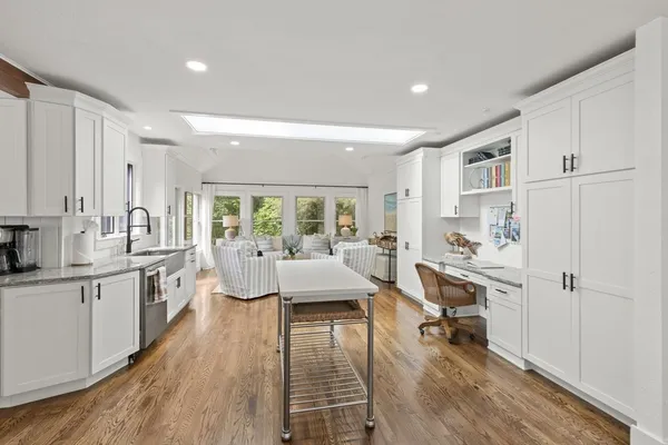 a kitchen with refrigerator a stove and chairs