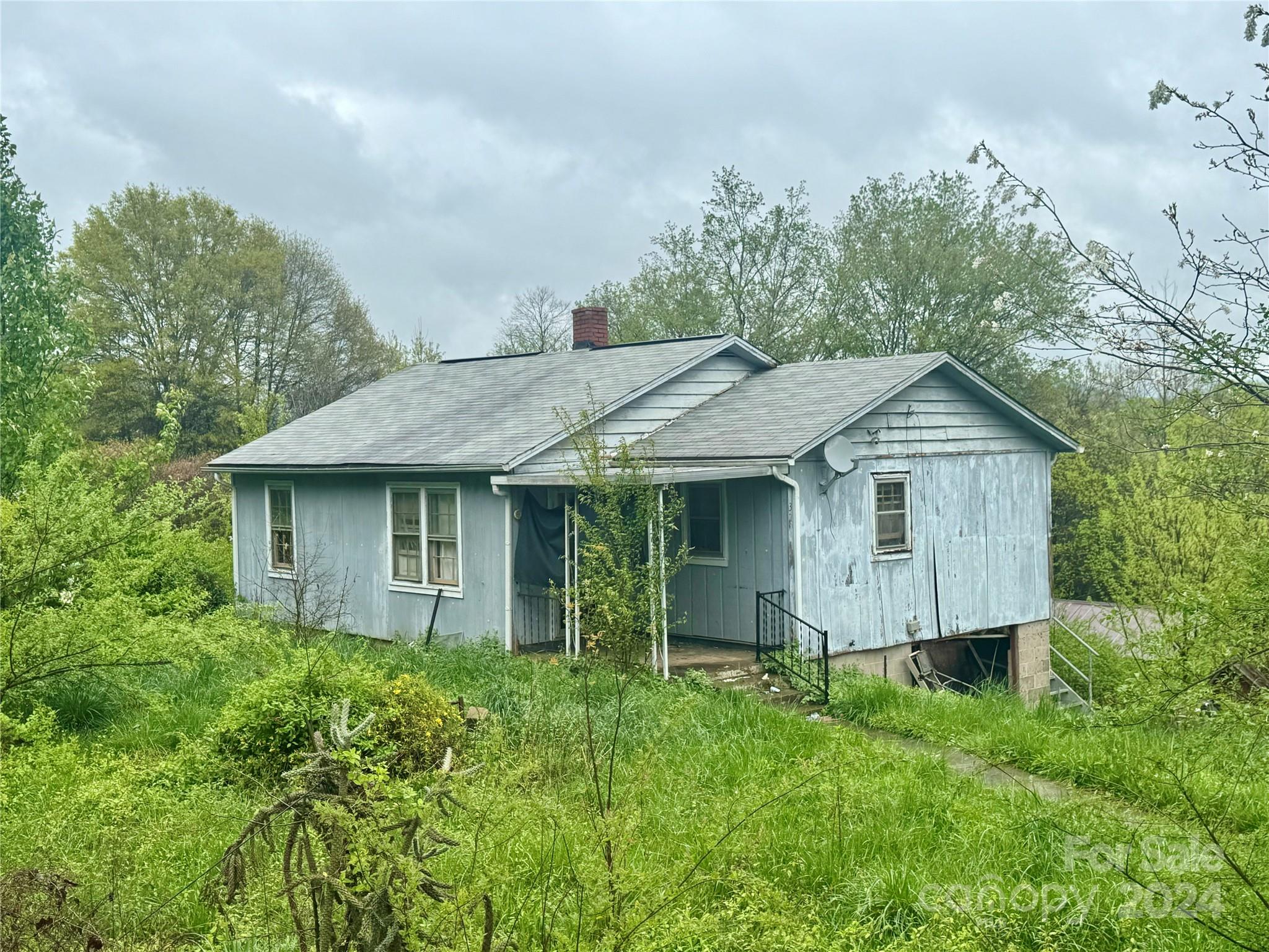 3292 Highway 64 Rutherfordton, NC 28139 - Photo 1 of 4 a view of a house with brick walls and a yard with plants