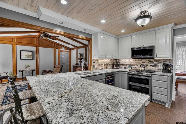 a kitchen with sink stove and refrigerator
