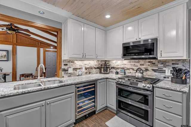 a kitchen with granite countertop a sink and cabinets