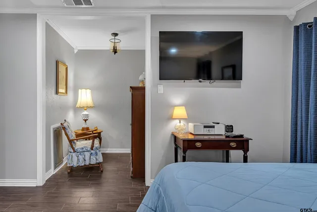 a bedroom with a bed and a flat screen tv