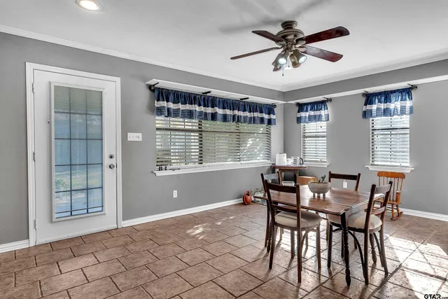 a dining room with furniture and window