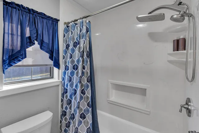 a bathroom with a bathtub and shower