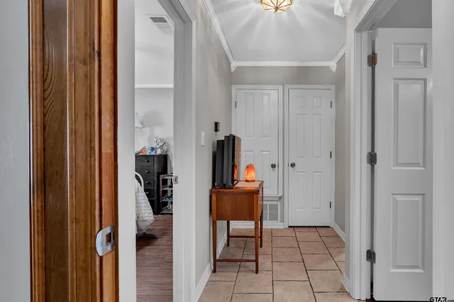 a view of a hallway with closet and front door