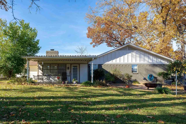 a view of a house with a yard porch and sitting area