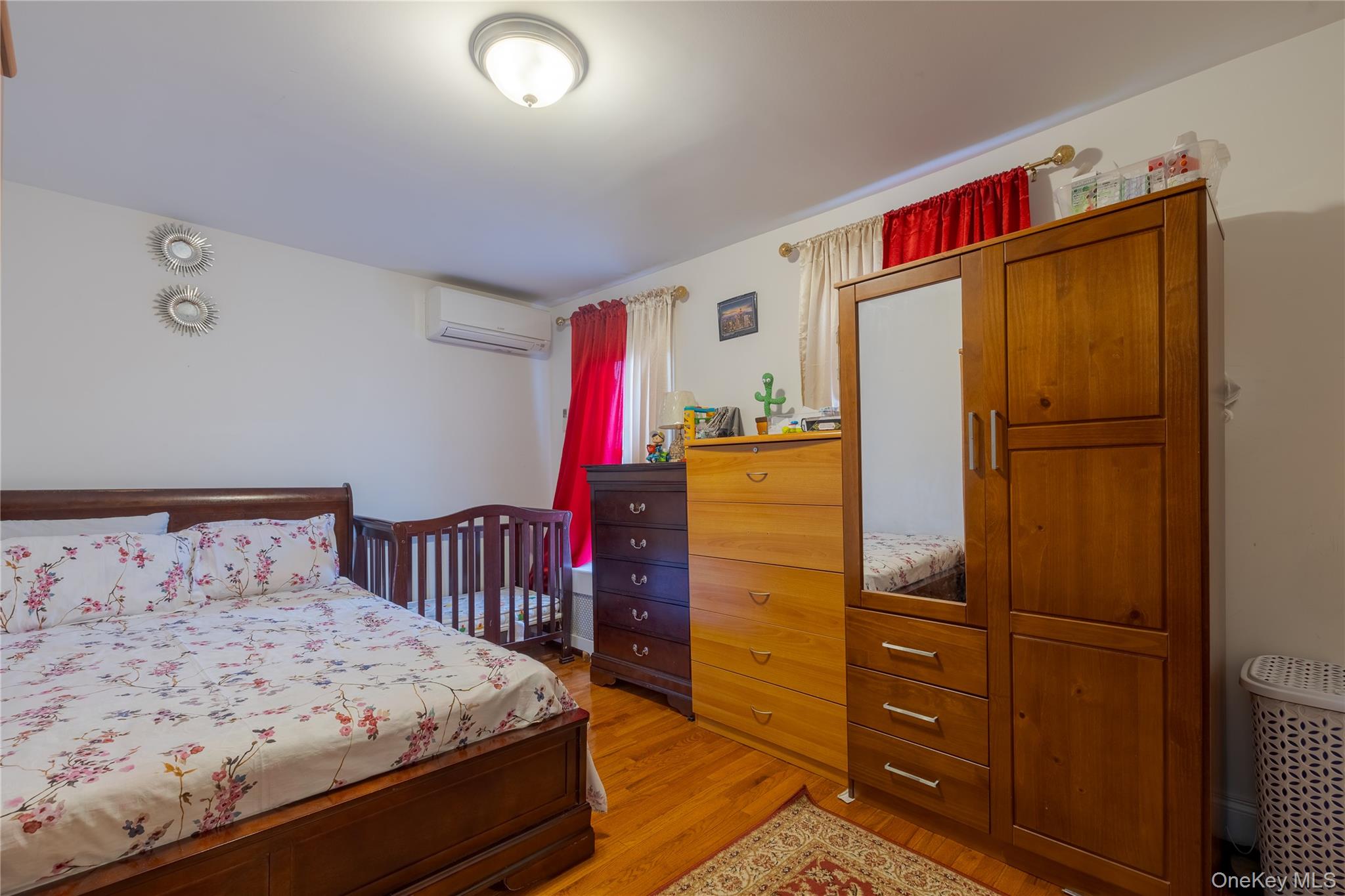 97-14 88th Street Queens, NY 11416 - Photo 7 of 14 a bedroom with a bed and a refrigerator