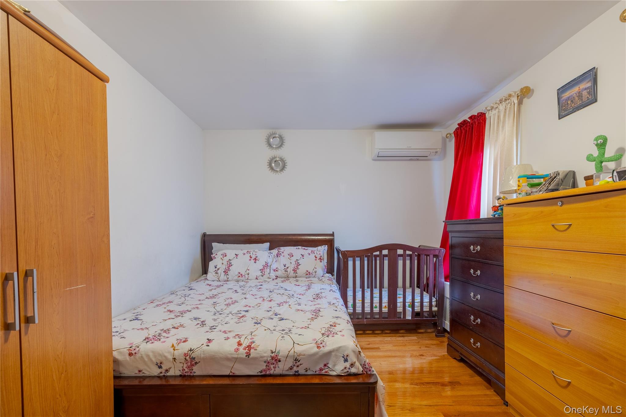 97-14 88th Street Queens, NY 11416 - Photo 8 of 14 a bedroom with a bed and a television