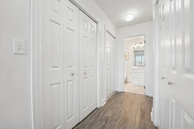 a view of a hallway with wooden floor