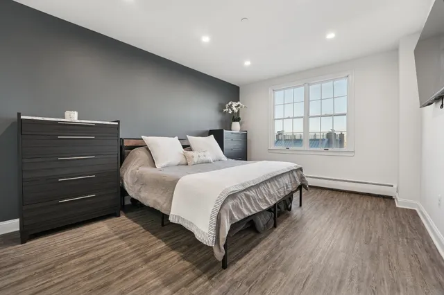 a bedroom with a bed and a window