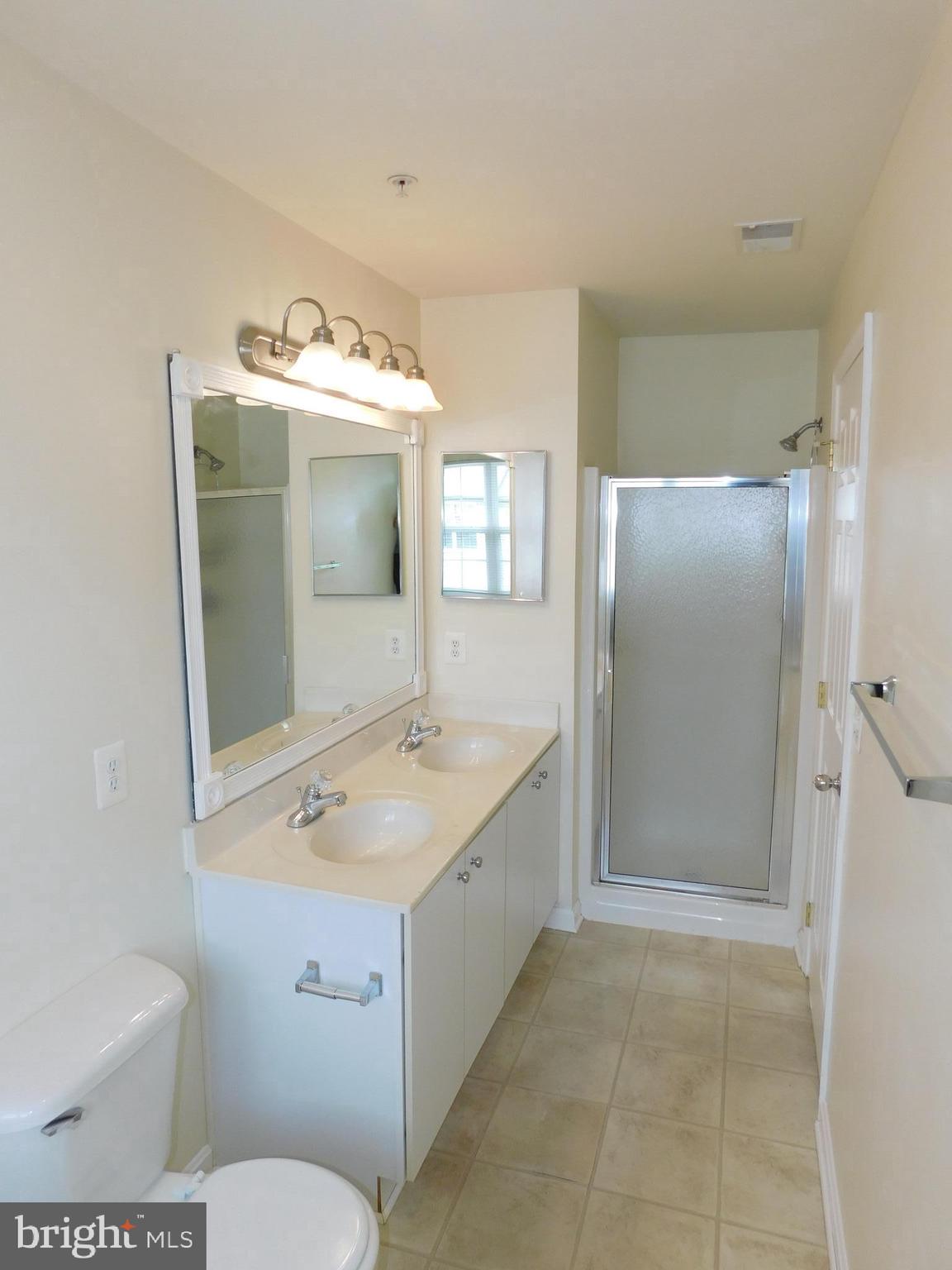 4036 Cutty Sark Road Baltimore, MD 21220 - Photo 19 of 25 a bathroom with a sink toilet and shower
