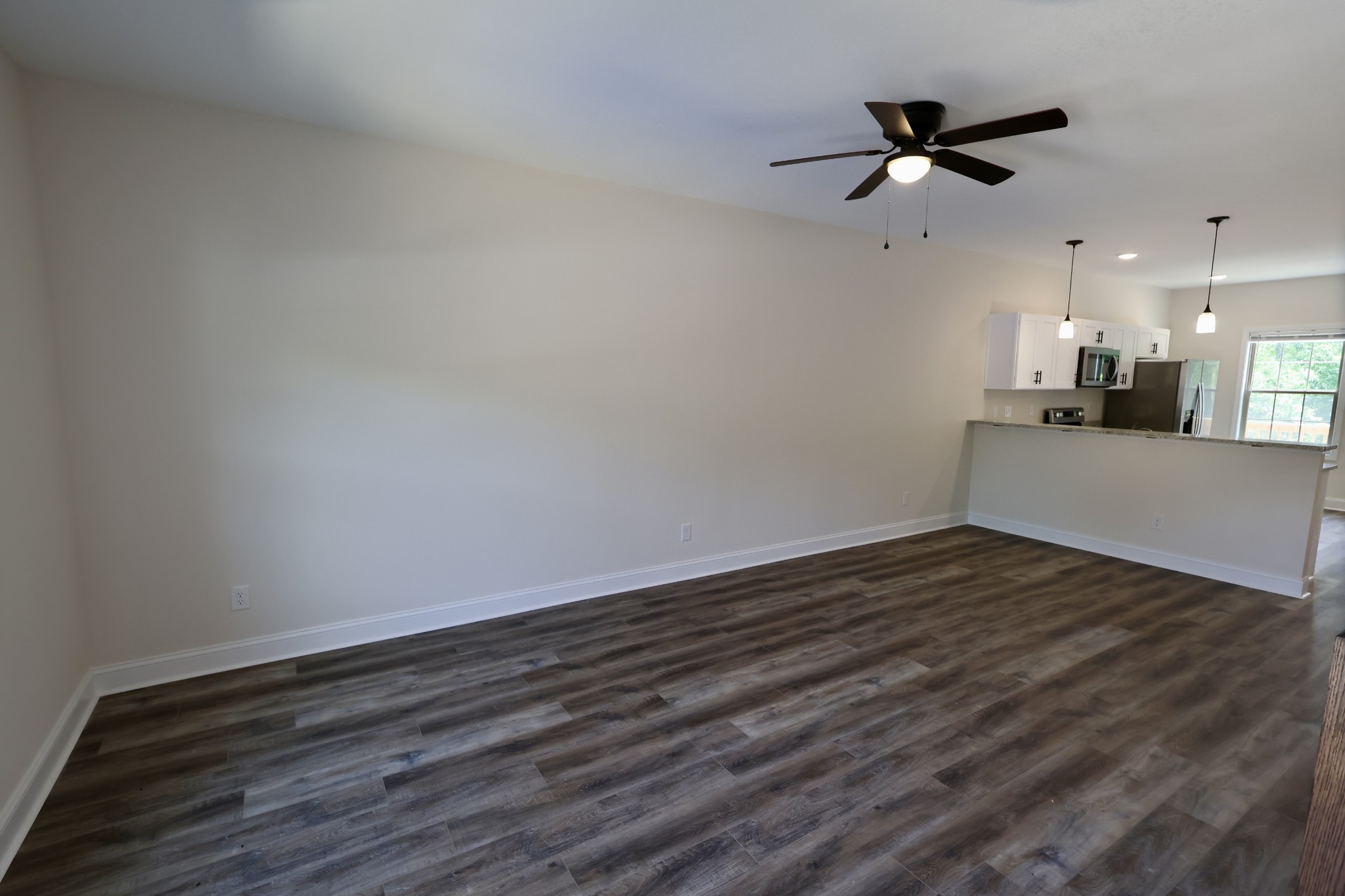 500 Peachers Mill Road, Unit B2 Clarksville, TN 37042 - Photo 3 of 33 a view of a room with wooden floor and a ceiling fan