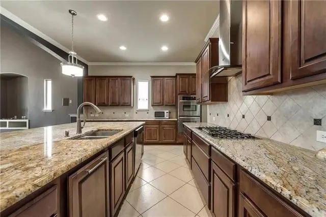 a kitchen with granite countertop a sink stove and cabinets