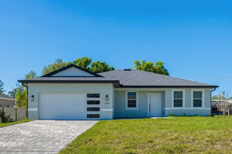 a front view of a house with a garden and yard