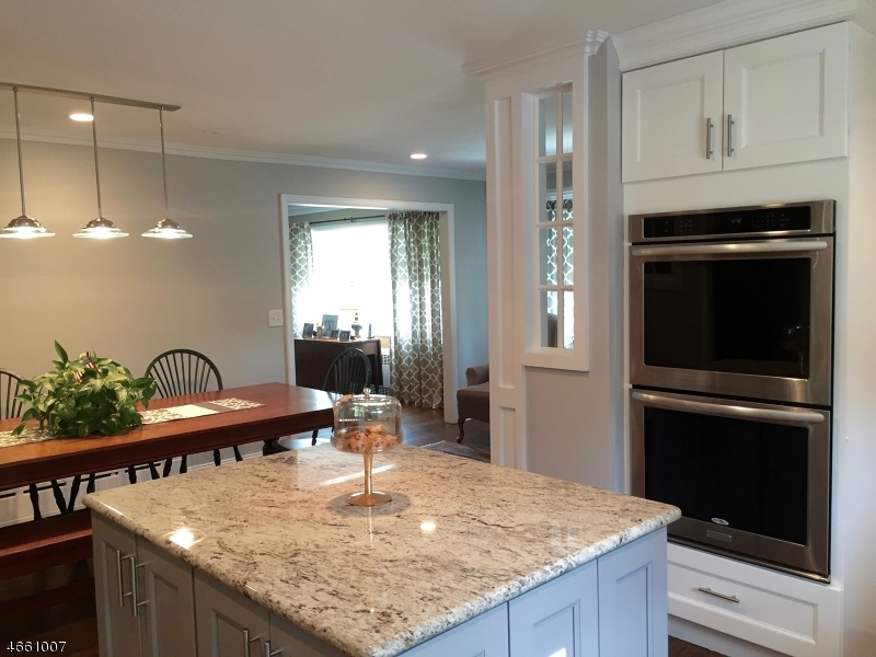 2 Spring Street Far Hills, NJ 07931 - Photo 2 of 16 a kitchen with kitchen island granite countertop a stove a sink a refrigerator dining table and chairs