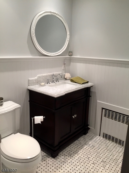 2 Spring Street Far Hills, NJ 07931 - Photo 9 of 16 a bathroom with a sink a toilet and a mirror