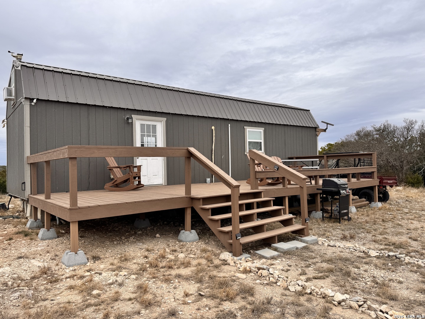 a view of a house with backyard and deck