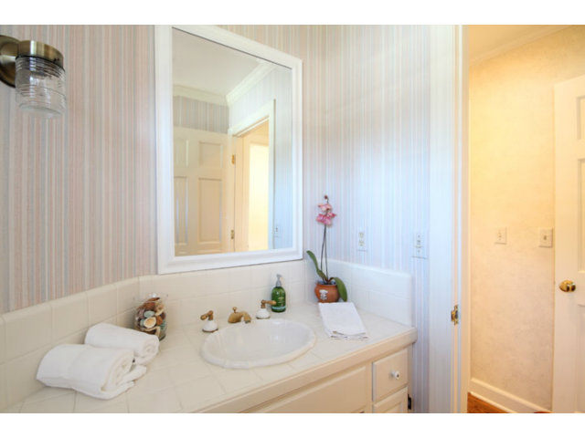 1212 Laurent Street Santa Cruz, CA 95060 - Photo 11 of 25 a bathroom with a sink vanity tub and a mirror