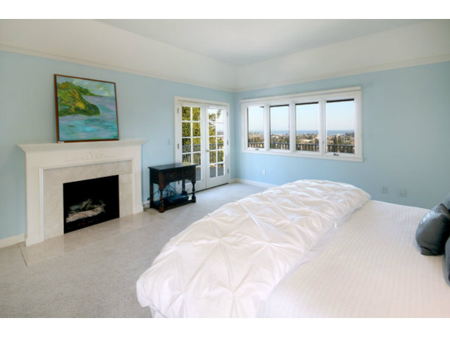 1212 Laurent Street Santa Cruz, CA 95060 - Photo 6 of 25 a bedroom with a bed and a fireplace